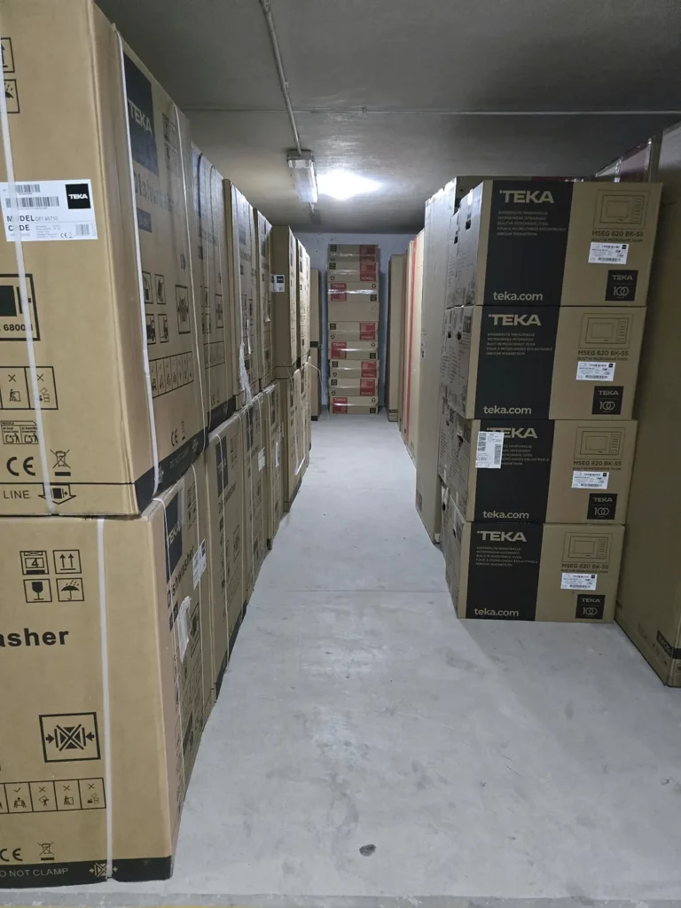 Boxed Teka appliances stored in the TODOMUEBLE warehouse in Guardamar